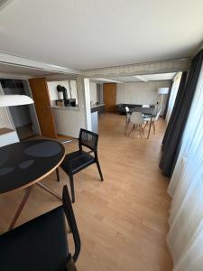 a living room with a table and chairs at Gästehaus Eichberg, Rheintal in Eichberg