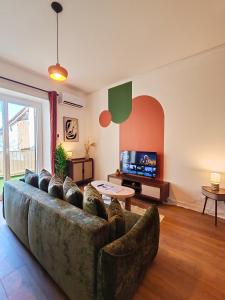 a living room with a couch and a tv at Ressource in Casteljaloux +44 photos