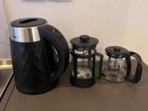 a black coffee maker and a tea kettle on a counter at Velvet studios Ioanna in Naousa