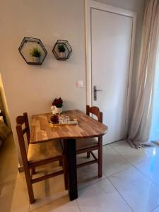 a wooden table with two chairs and a table with flowers on it at Velvet studios Ioanna in Naousa +8 photos