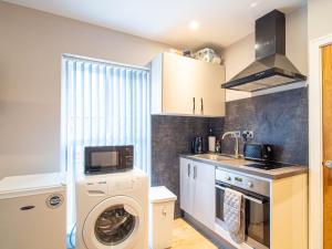 a kitchen with a washer and dryer in it at 1 Bed Cozy Flat City Center in Sheffield