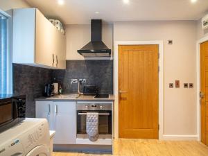 a kitchen with a sink and a stove top oven at 1 Bed Cozy Flat City Center in Sheffield