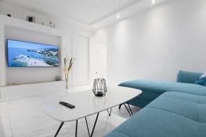 a living room with a blue couch and a table at Apartman Lucija in Selce