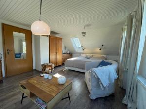 a bedroom with a bed and a table at Landhaus am Deich in Dornum