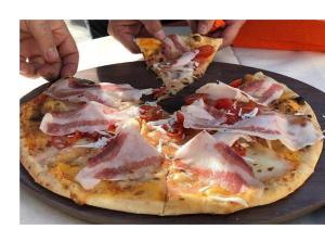 two slices of pizza on a plate with one slice missing at Supramonte Urzulei in Urzulei