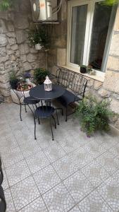 a patio with a table and chairs on a patio at Apartman Lucija in Selce