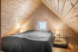 a bedroom with a large bed in a attic at 529-Lemvig-Lokkevej-61-A in Lemvig