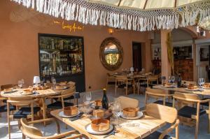a restaurant with wooden tables and chairs and a mirror at Camping la Peiriere - Lodge en Pays Cathare in Tuchan