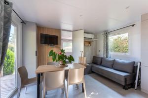 a living room with a couch and a table at Domaine de Miremer in La Garde-Freinet