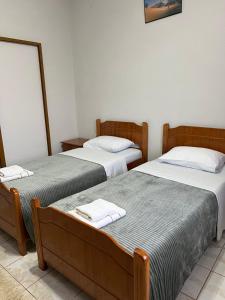a room with two beds with white towels on them at Camping & Guest House Herges in Udënisht +103 photos