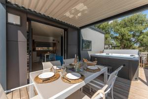 a patio with a white table and a grill at Domaine de Miremer in La Garde-Freinet