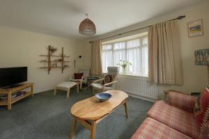 a living room with a couch and a table at 16 Manesty View in Keswick