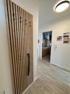 a sliding door in a room with a hallway at Strandhotel Wohnung 61 in Dahme