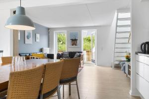 a dining room and living room with a table and chairs at 0457-Romo-Vestergade-119-App-57 in Høm