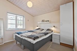 a bedroom with a bed and a window at 0379-Romo-Stormengevej-14 in Høm
