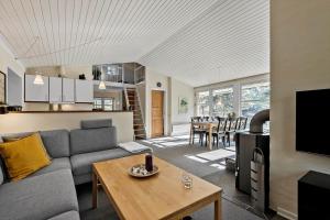 a living room with a couch and a table at 0379-Romo-Stormengevej-14 in Høm