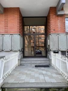 an entrance to a brick building with a glass door at Alloggio Manzoni in Asti