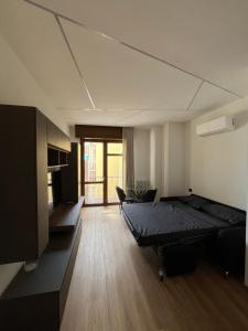 a room with a bed and a chair in it at Alloggio Manzoni in Asti