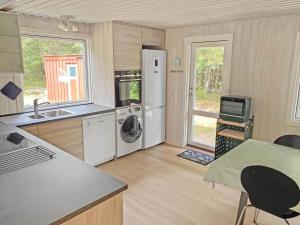 a kitchen with a refrigerator and a sink and a stove at 0127-Romo-Umanaksvej-4 in Høm