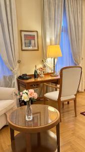 a living room with a vase of flowers on a table at FLEUR DE LIS HOTEL in Prague