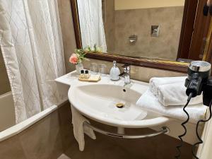 a photographer taking a picture of a bathroom sink at FLEUR DE LIS HOTEL in Prague +66 photos