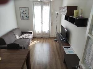 a living room with a couch and a television at Brunate Funicolare Apartament in Brunate