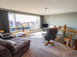 a living room with a couch and a chair at Seascape in Hunstanton