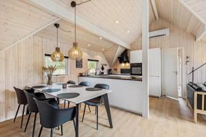 a kitchen and dining room with a table and chairs at 0218-Romo-A-Hveyselsvej-13 in Høm