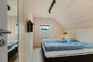a bedroom with two beds and a window at 0218-Romo-A-Hveyselsvej-13 in Høm