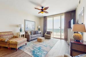 a living room with a couch and a tv at Spanish Key 304 in Perdido Key