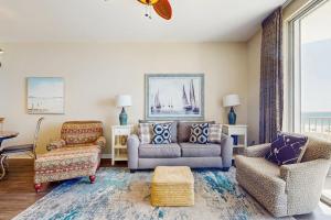 a living room with a couch and chairs and a window at Spanish Key 304 in Perdido Key