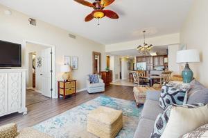 a living room with a couch and a ceiling fan at Spanish Key 304 in Perdido Key +23 photos