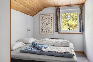 a bedroom with a large bed and a window at 0326-Romo-Sandloberen-3 in Høm