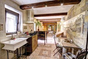 a large kitchen with a sink and a counter at Villa da Winci in Odesa
