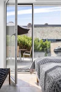 a bedroom with a bed and a view of a patio at 1165-Romo-Gulirisvej-841 in Høm