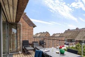 a patio with chairs and a table on a balcony at 1165-Romo-Gulirisvej-841 in Høm +22 photos