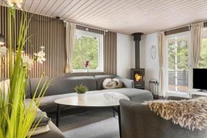 a living room with a couch and a table at 0167-Romo-Julianehab-12 in Høm
