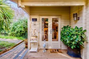 a porch of a house with a cat and ducks at Duck Lodge B&B in Pyecombe