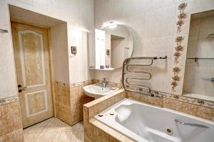 a bathroom with a tub and a sink at Villa da Winci in Odesa +124 photos