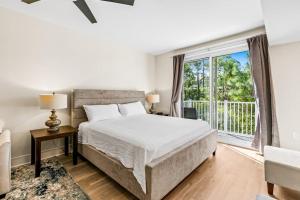 a bedroom with a bed and a large window at Lasata #3112 in Destin