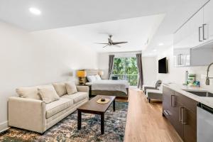 a white living room with a couch and a table at Lasata #3112 in Destin