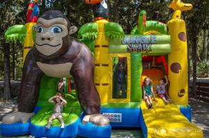 a inflatable monkey park with children playing on it at Camping la Peiriere - Lodge en Pays Cathare in Tuchan