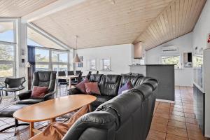 a living room with a couch and a table at 0403-Romo-Lyngvejen-44-C in Høm