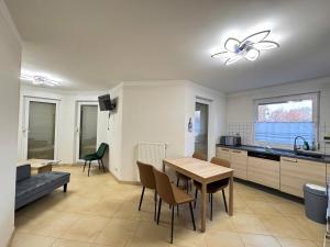 a kitchen and dining room with a table and chairs at Asiatisches Ferienhaus in Merseburg