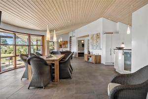a kitchen and living room with a table and chairs at 0335-Romo-Vestergardsvaenget-2 in Høm