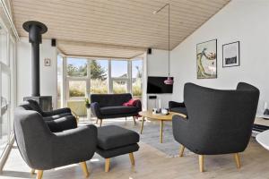 a living room with chairs and a fireplace at 0049-Romo-Magevej-5 in Høm