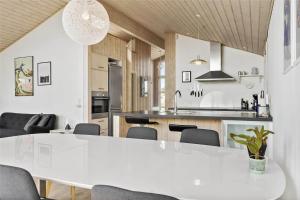 a kitchen and dining room with a white table and chairs at 0049-Romo-Magevej-5 in Høm