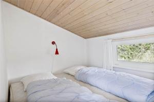 a bedroom with two beds and a window at 0049-Romo-Magevej-5 in Høm