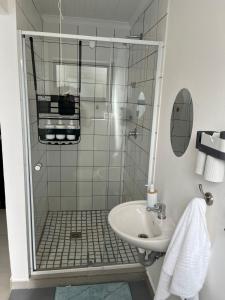 a bathroom with a shower and a sink at Blue Moon Charming 2 Bed Poolside Apartment in Bellville