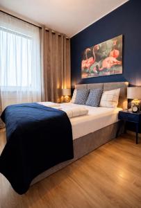 a bedroom with a large bed and a large window at Modern 2-Room Apartment with Large Balcony & Private Parking in Gdańsk